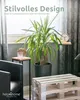 A living room scene with a plant, side table, and a coffee table made from pallets. Produktbild-Vorschau