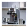 A stainless steel espresso machine with two glasses on top, sitting on a countertop. Produktbild-Vorschau