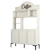 A cream-colored cabinet with black legs and a decorative 'Coffee' sign on top. Produktbild-Vorschau
