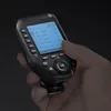 A hand holding a black camera transmitter with a lit screen. Náhľad obrázku produktu