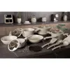 A collection of kitchenware, including pots, pans, and utensils, arranged on a countertop. Anteprima dell’immagine prodotto