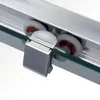 A close-up view of the rollers and track mechanism of a sliding shower door. Produktbild-Vorschau