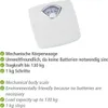 A white mechanical body scale with a dial display, accompanied by a list of its features in both German and English. Produktbild-Vorschau