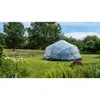 A transparent pool cover is set up on a grassy lawn in a garden setting, surrounded by trees and plants. Náhľad obrázku produktu