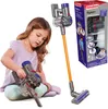 A young girl playing with a toy Dyson vacuum cleaner. Voir les images du produit
