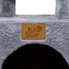 A close-up of a grey cat tree with a brown leather tag that says "Pet Story". Náhled obrázku produktu