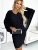 A woman is posing in a black dress, holding a clutch. Anteprima dell’immagine prodotto