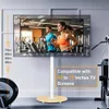 A TV stand with a TV displaying people exercising in a gym setting. Produktbild-Vorschau