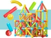 A colorful construction of magnetic building blocks, with some loose pieces scattered around. Produktbild-Vorschau