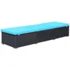 A long, black rattan sun lounger with blue cushions, shown from a side angle against a white background. Náhľad obrázku produktu