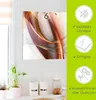A square wall clock with an abstract orange and red design is displayed on a white wall next to a window. To the right of the clock, there are three circular icons with text describing features of the clock. Produktbild-Vorschau