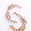 A dog toy made of braided rope with knots, arranged in a stylized 'S' shape on a white background. Produktbild-Vorschau