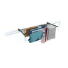 A drying rack with clothes hanging on it, mounted on a window frame. Produktbild-Vorschau