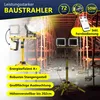 A construction site with scaffolding and a bright yellow LED work light on a tripod. Produktbild-Vorschau