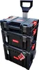 A stack of three black toolboxes with red accents, one on top of the other, with a silver retractable handle and wheels on the bottom unit. Náhled obrázku produktu