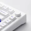 A close-up view of a white mechanical keyboard with blue lettering on some keys and a white rotary knob. Voir les images du produit