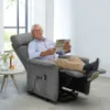 An elderly man is relaxing in a recliner chair, reading a newspaper. Produktbild-Vorschau