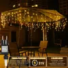 Outdoor patio scene at night with umbrella lights. Produktbild-Vorschau
