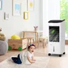 A baby crawling on a rug in a room with a portable air cooler, a toy box, and a table with chairs. Produktbild-Vorschau
