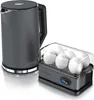 A gray electric kettle and a gray egg cooker with white eggs are displayed on a white reflective surface. Voir les images du produit