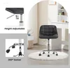A black office chair with wheels is shown in a room with a white rug and a vanity. Náhľad obrázku produktu