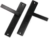 Two black door handles with mounting plates are shown diagonally on a white background. Náhled obrázku produktu