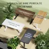 Four different desk color options are displayed with descriptive text, surrounded by plants. Produktbild-Vorschau