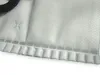 A close-up view of a white vacuum cleaner bag with a textured surface and a stitched seam. Produktbild-Vorschau