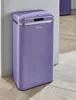 A purple retro-style trash can with a silver trim and lid is shown standing next to a light gray wall on a wooden floor. Produktbild-Vorschau
