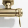 A close-up shot of a gold-colored faucet handle and part of the pipe. Anteprima dell’immagine prodotto