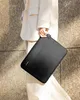 A person holding a black laptop bag. Produktbild-Vorschau