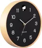 A Karlsson cuckoo clock with a black face and a light wood frame. Produktbild-Vorschau
