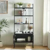 A black ladder shelf with four shelves and a cabinet at the bottom, decorated with various items. Anteprima dell’immagine prodotto