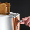A close-up shot of a person's hand operating a toaster with two slices of toast inside. Produktbild-Vorschau