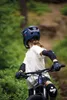 A person riding a mountain bike on a trail. Produktbild-Vorschau