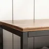 A close-up view of the corner of a shoe cabinet with a wooden top and black metal frame. Podgląd zdjęcia produktu