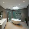A modern, luxurious bathroom with a freestanding bathtub, a large mirror, and a vanity. Náhled obrázku produktu