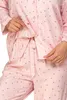 Close-up of a person wearing pink polka dot pajamas. Produktbild-Vorschau