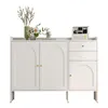 A white sideboard with arched doors and drawers, decorated with flowers and a calendar. Produktbild-Vorschau