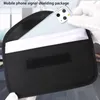 A hand in a white glove is placing a smartphone into a black signal shielding pouch. Produktbild-Vorschau