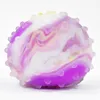 A close-up studio shot of a stress ball with a marbled pattern. Produktbild-Vorschau