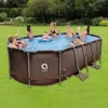 A group of people, including adults and children, are enjoying themselves in an oval-shaped above-ground swimming pool set up in a grassy backyard. Anteprima dell’immagine prodotto