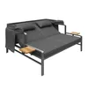 A dark gray outdoor sofa or daybed with two pillows and wooden side tables, set against a white background. Anteprima dell’immagine prodotto