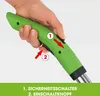 A hand is shown holding a green handle of a tool, with arrows indicating how to operate the safety switch and the power button. Produktbild-Vorschau