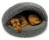 A dog sleeping in a round, gray, plush dog bed. Produktbild-Vorschau