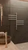A modern bathroom setting with a wall-mounted towel warmer and a sink. Náhľad obrázku produktu