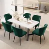 A dining set with a marble-top table and six green velvet chairs in a modern kitchen setting. Anteprima dell’immagine prodotto