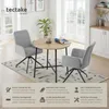 A dining set with two chairs and a round table in a bright, modern room setting. Náhled obrázku produktu