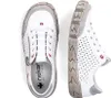 A pair of white Rieker women's slip-on shoes with gray accents and red detailing, shown from a top-down and side view. Podgląd zdjęcia produktu