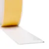 A roll of white self-adhesive tape with a yellow protective layer being unrolled. Produktbild-Vorschau